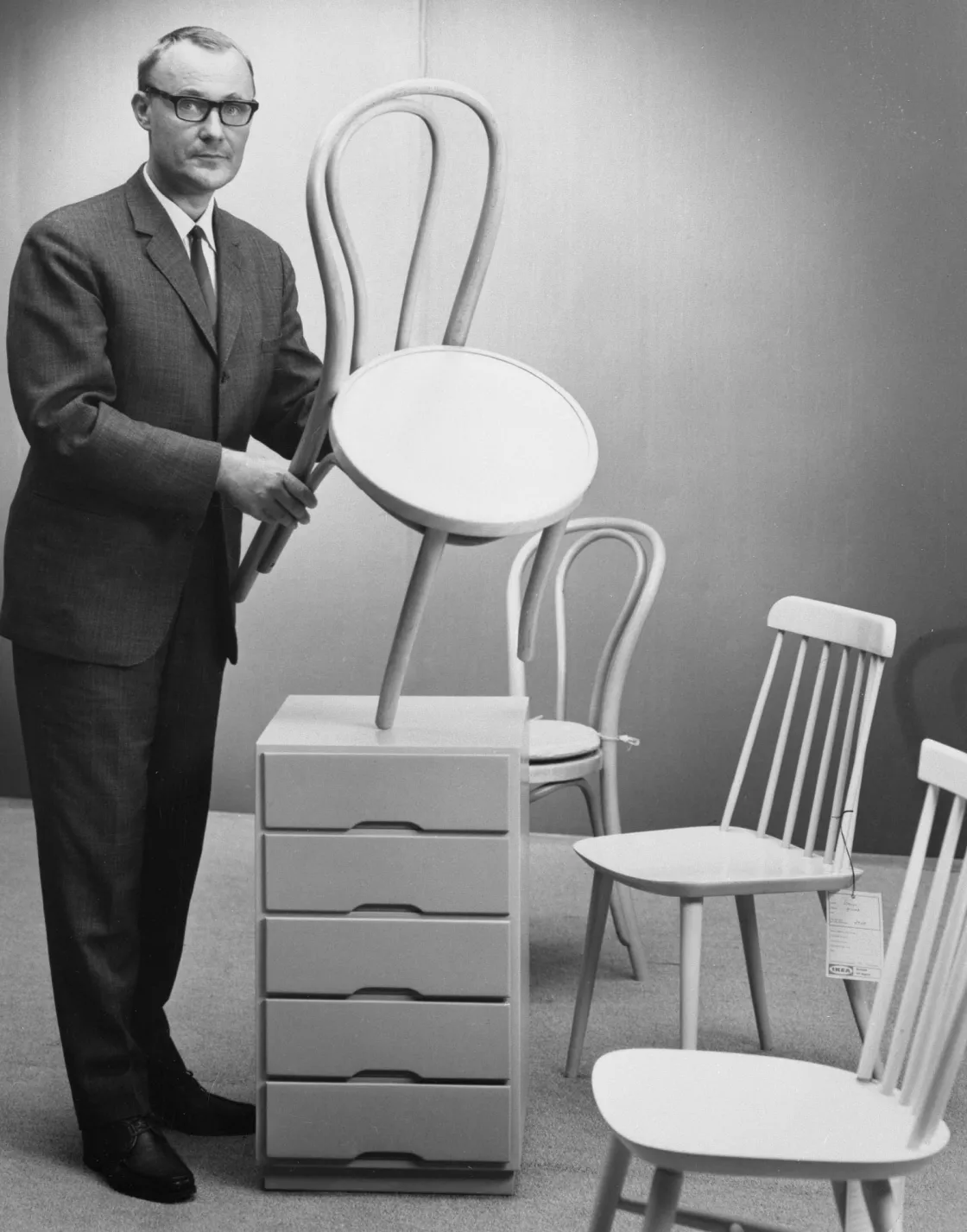 Ingvar holding the ÖGLA chair, one of the great classics