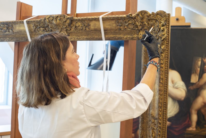 Restorer working on the consolidation of the frame of Rubens’s “Venus and Cupid”